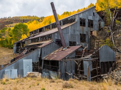 Abandoned mine buildings on an autumn hillside